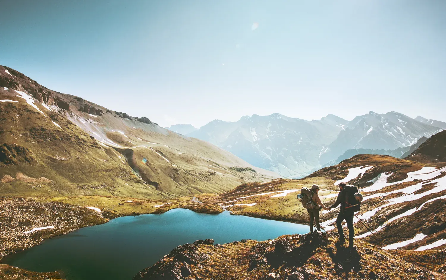 A hiker overlooking an alpine lake